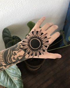 Black Sun tattoo on the left hand