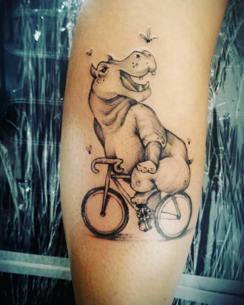 Black Animal tattoo of a hippo on the bike