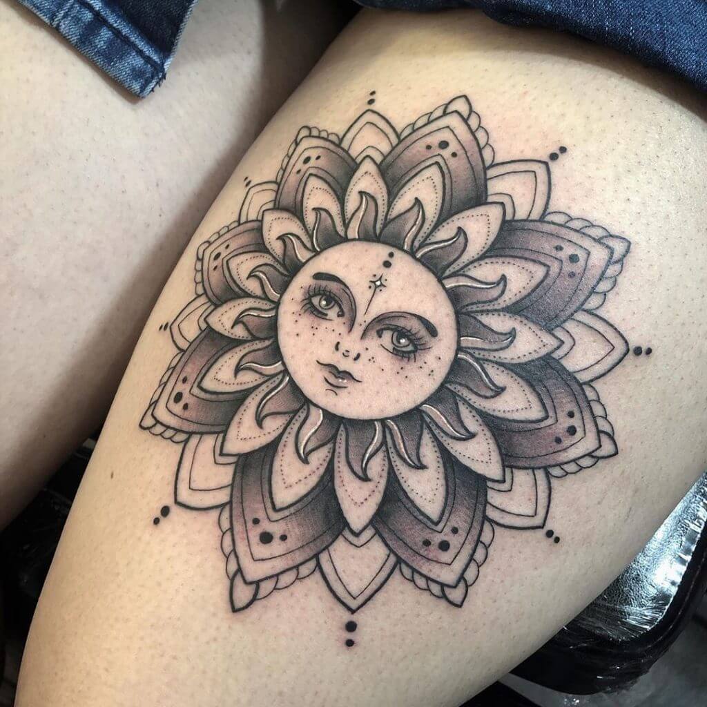 Black Sun tattoo on the left thigh