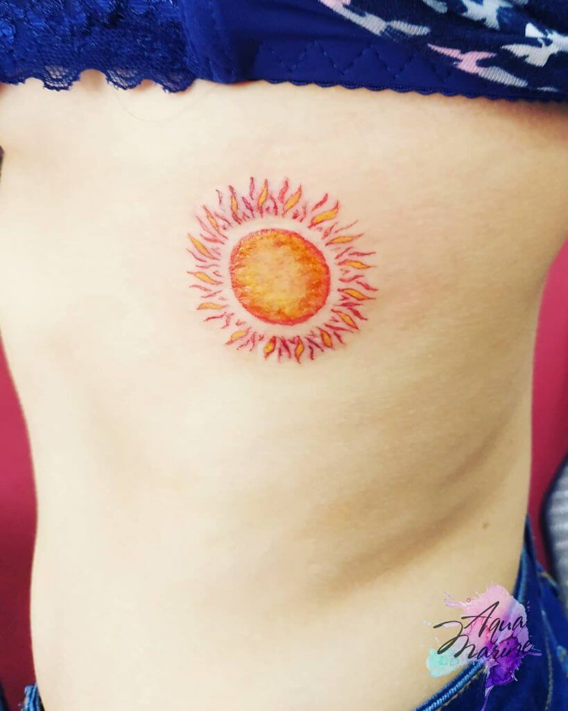 Color Sun tattoo on the ribs