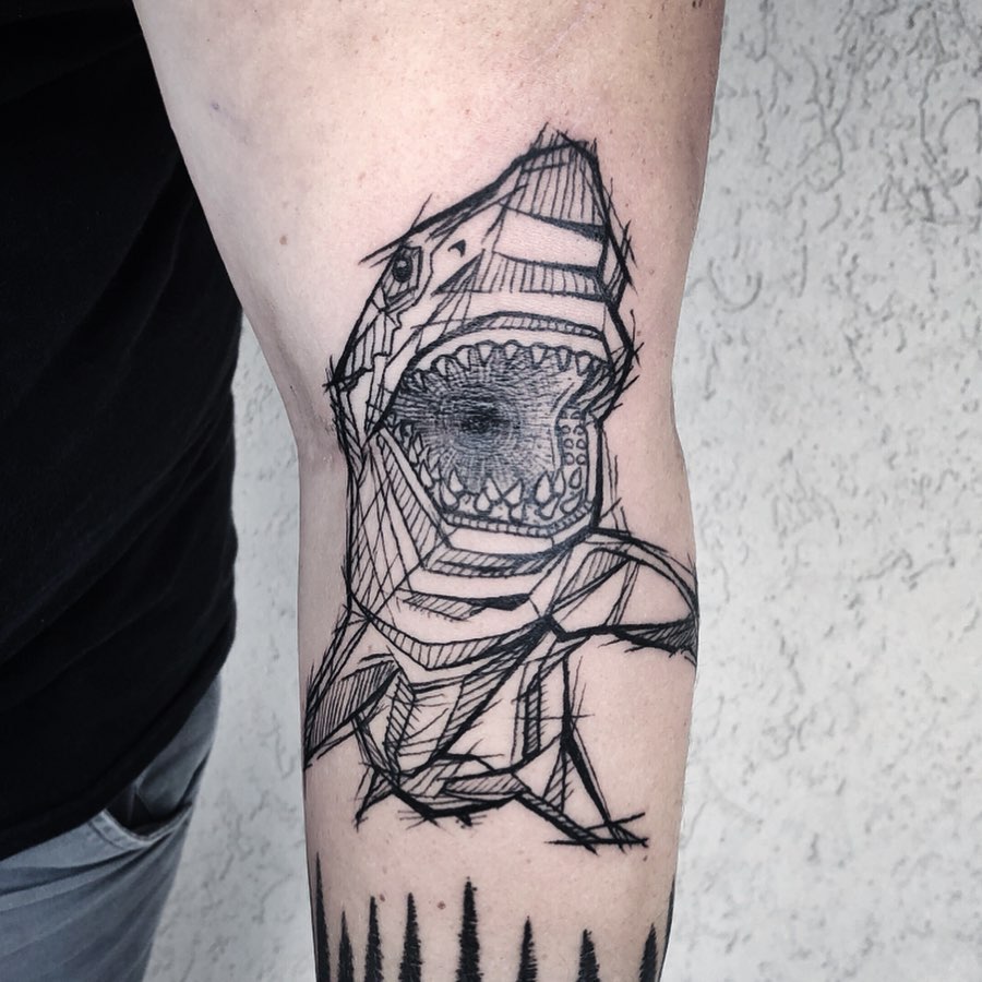 Black Animal tattoo of a shark on the left arm