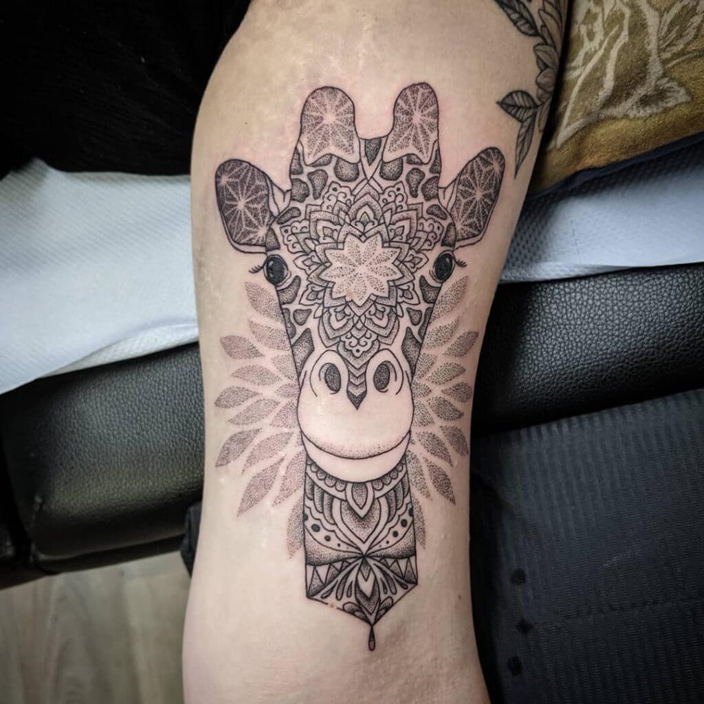 Black Animal tattoo of a giraffe on the right arm