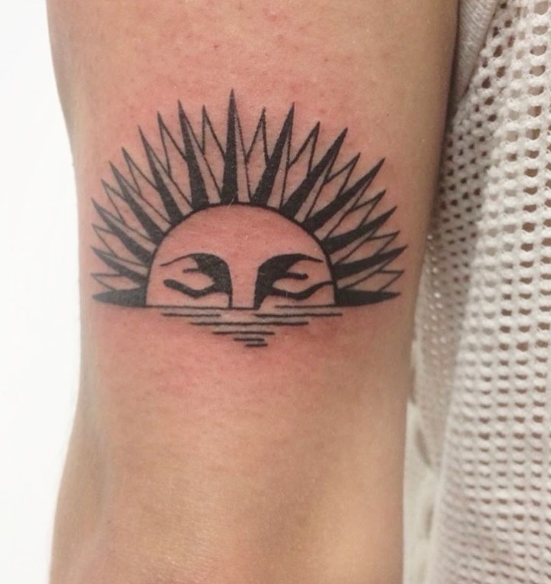 Black Sun tattoo on the arm