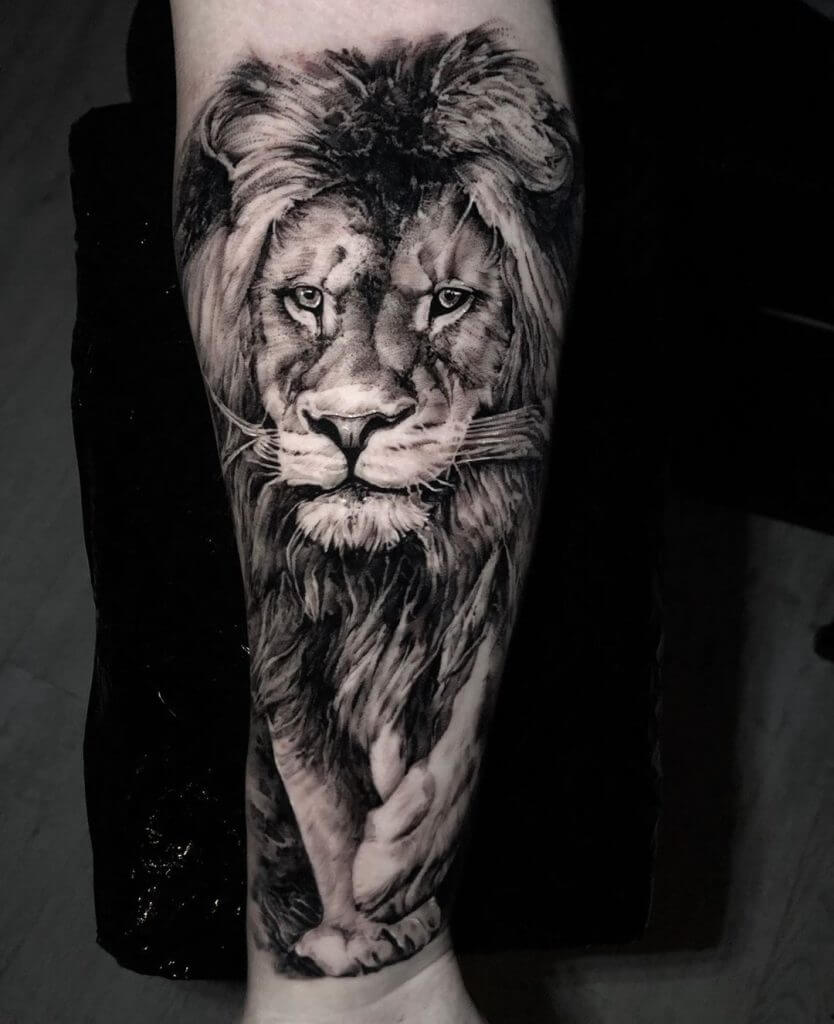 Black Animal tattoo of a lion on the left forearm
