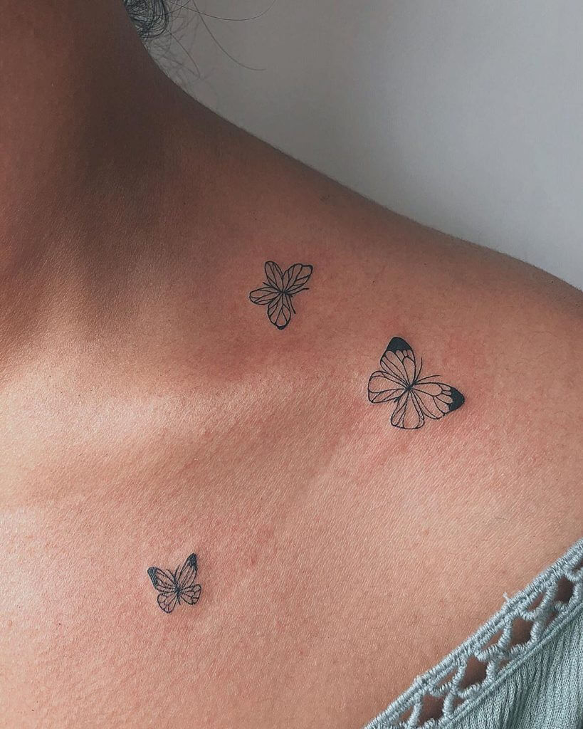 Small Black Butterflies tattoos on the left collar bone
