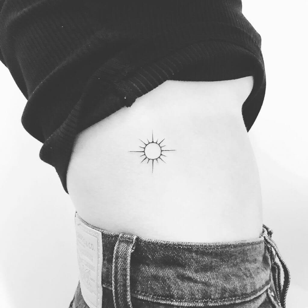 Black Sun tattoo on the ribs