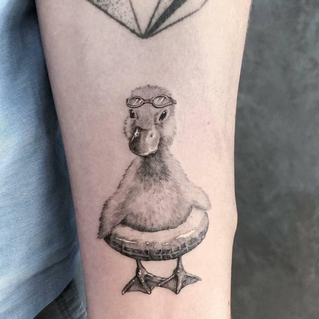 Black Animal tattoo of a duck on the left forearm