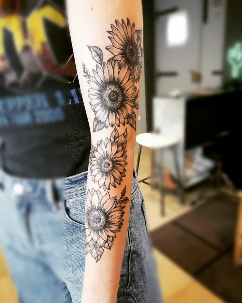 Black Flowers tattoo on the left arm