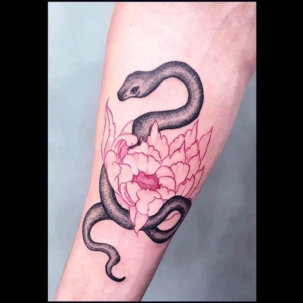 Animal tattoo of a snake and a flower on the forearm