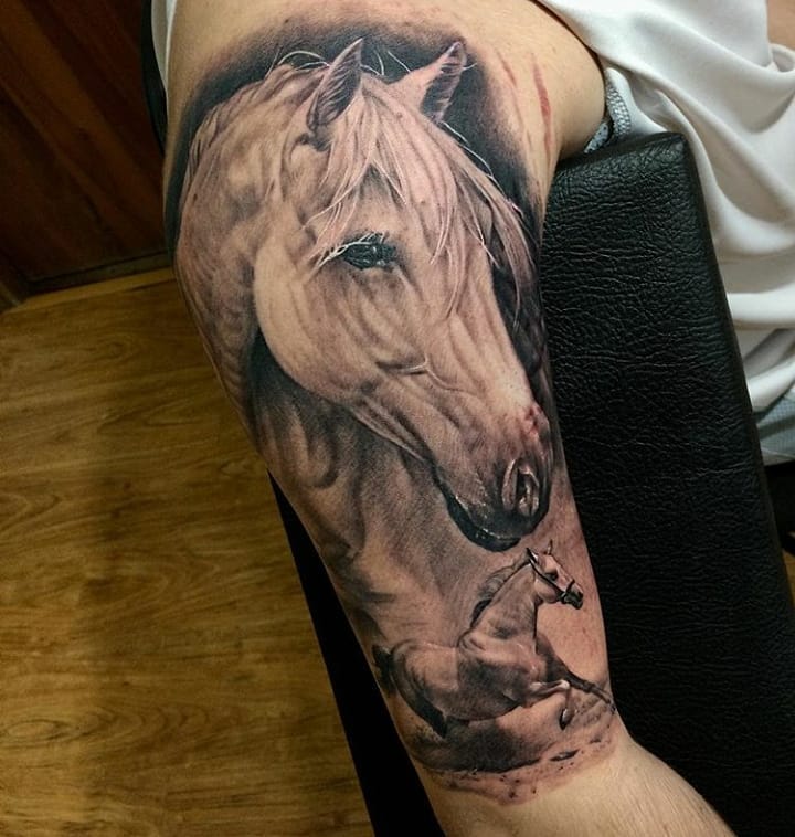 Black and Gray Animal tattoo of horses on the right arm