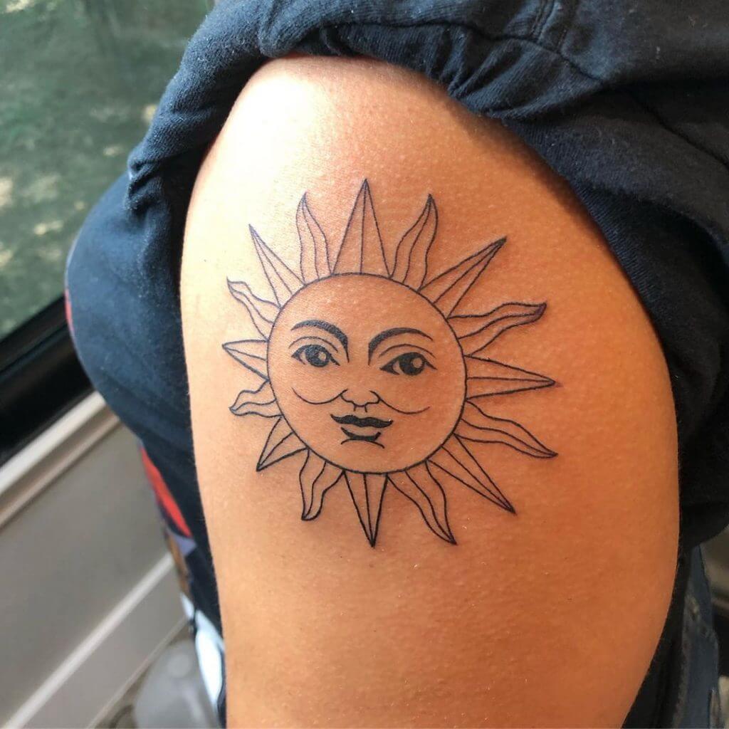 Black Sun tattoo on the left shoulder