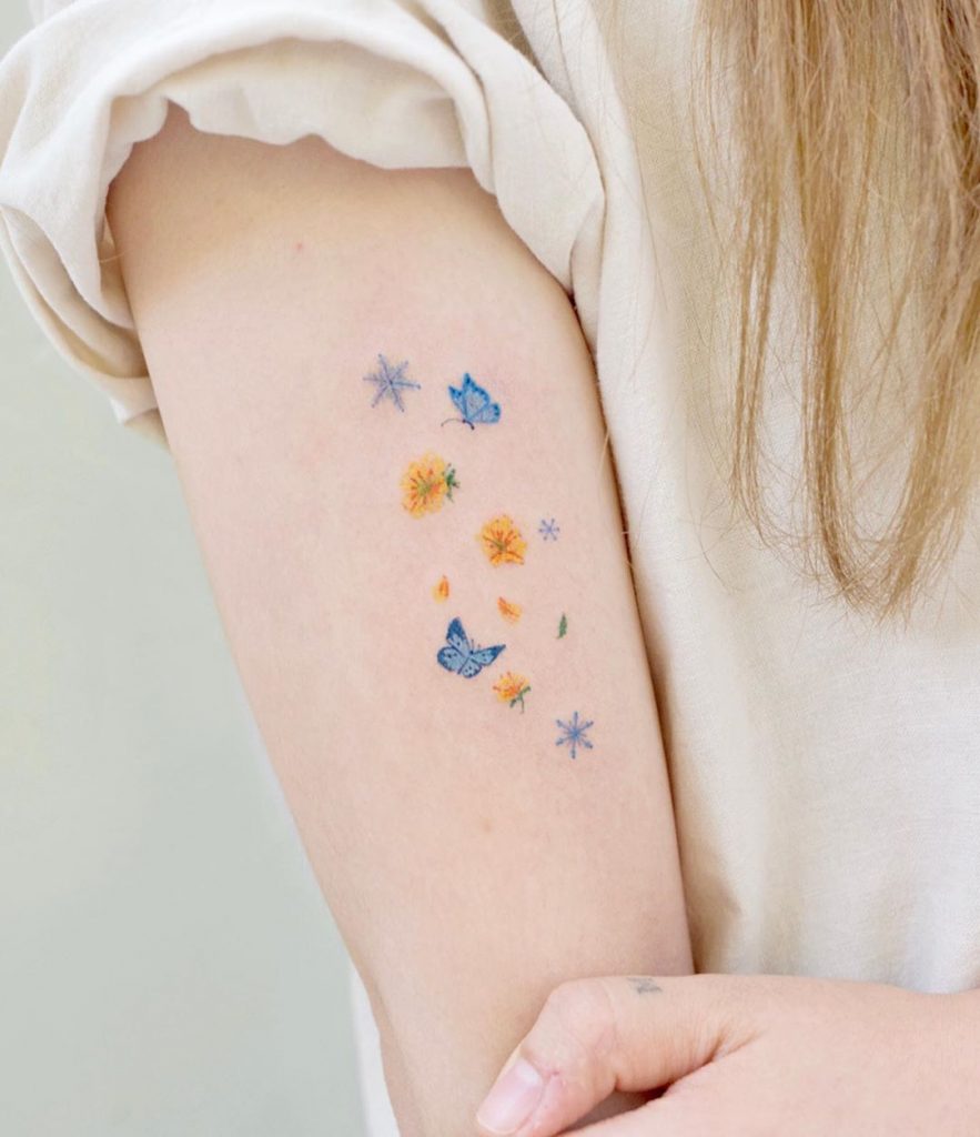Small Color Butterfly tattoo on the right arm