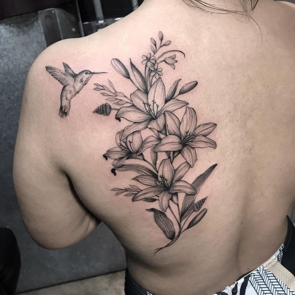 Black Flowers tattoo with hummingbird on the back