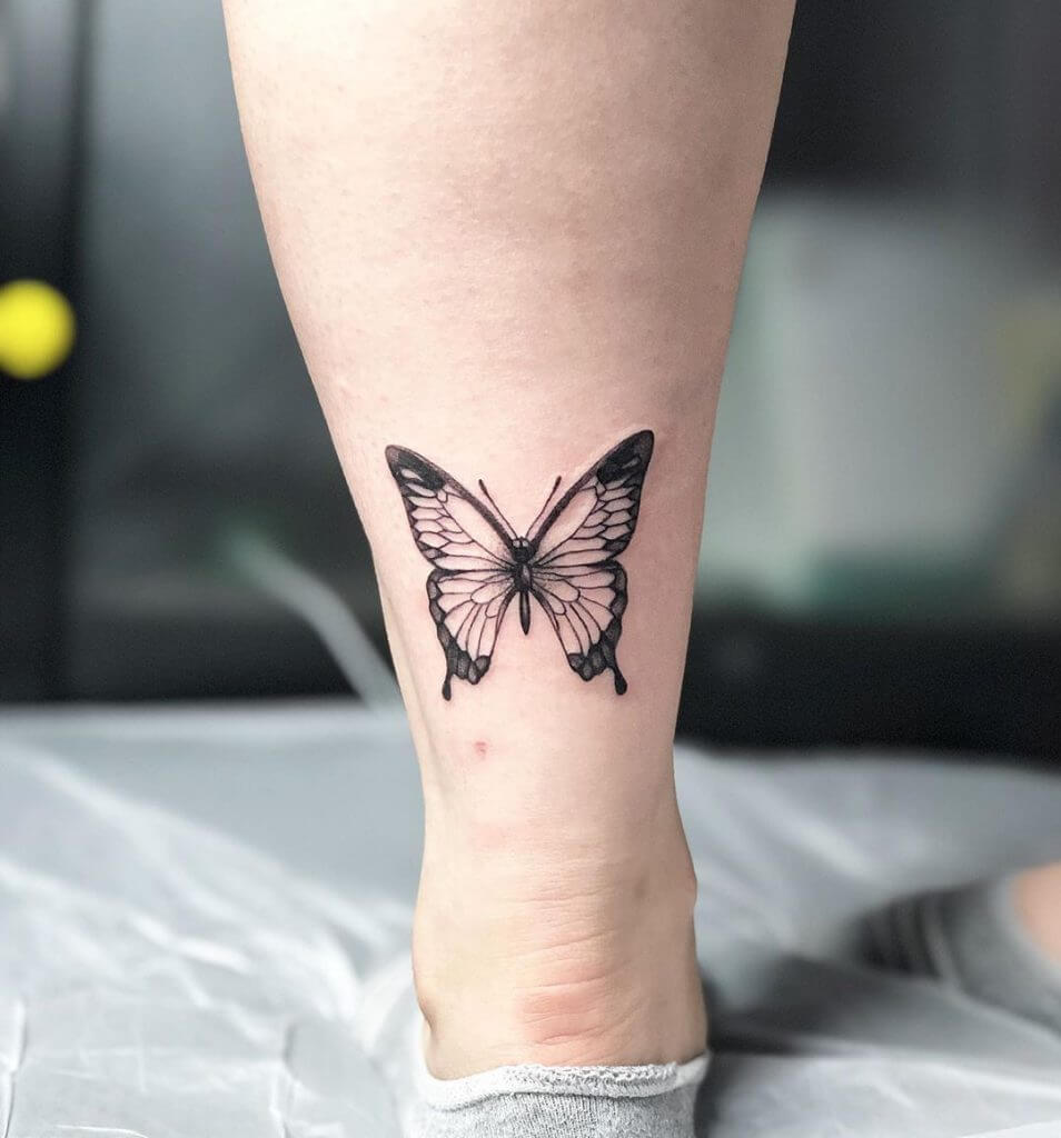 Black Butterfly tattoo on the foot