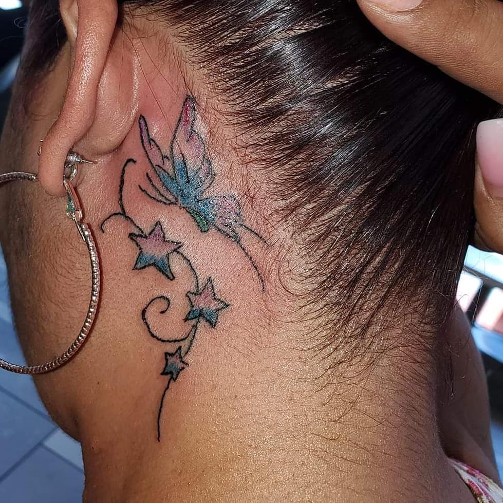 Color Butterfly tattoo with stars behind the ear