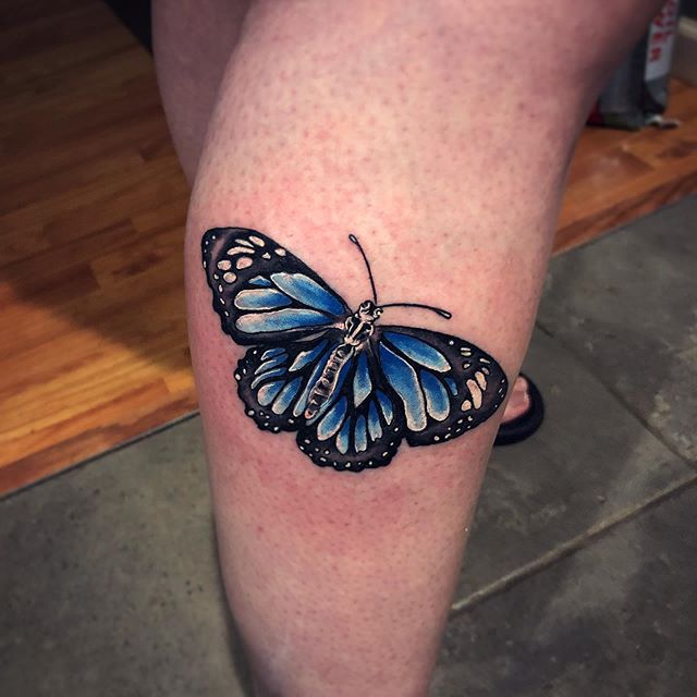 Color female tattoo of a butterfly on the calf
