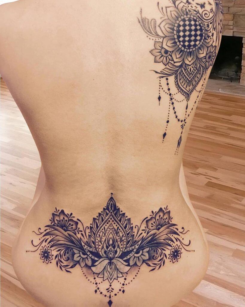 Mandala tattoo on the womans lower back
