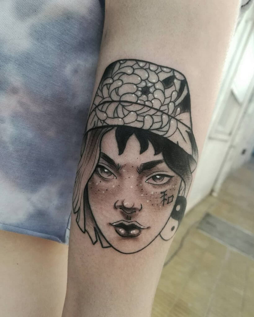 Neo traditional tattoo for woman of a female face with cap on her head on the left arm