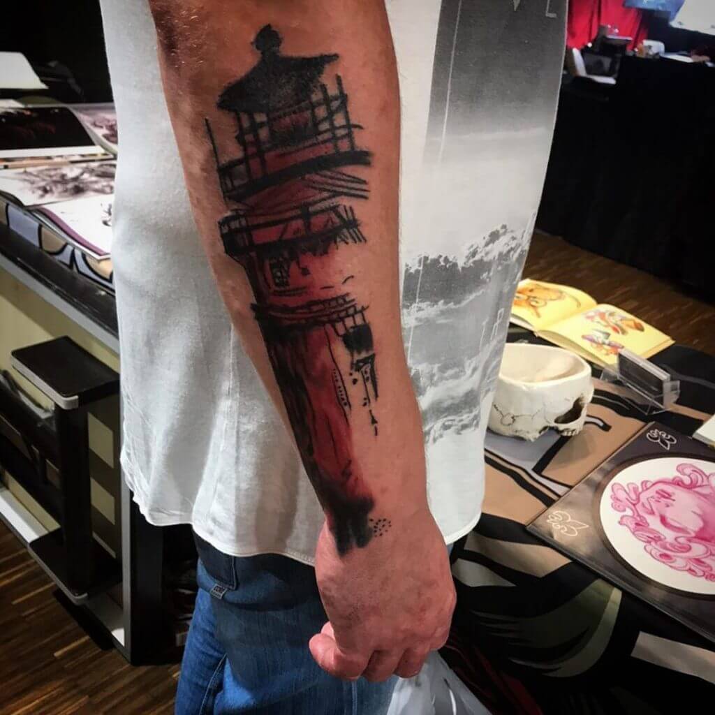 Mens neotraditional tattoo of a lighthouse on the right forearm