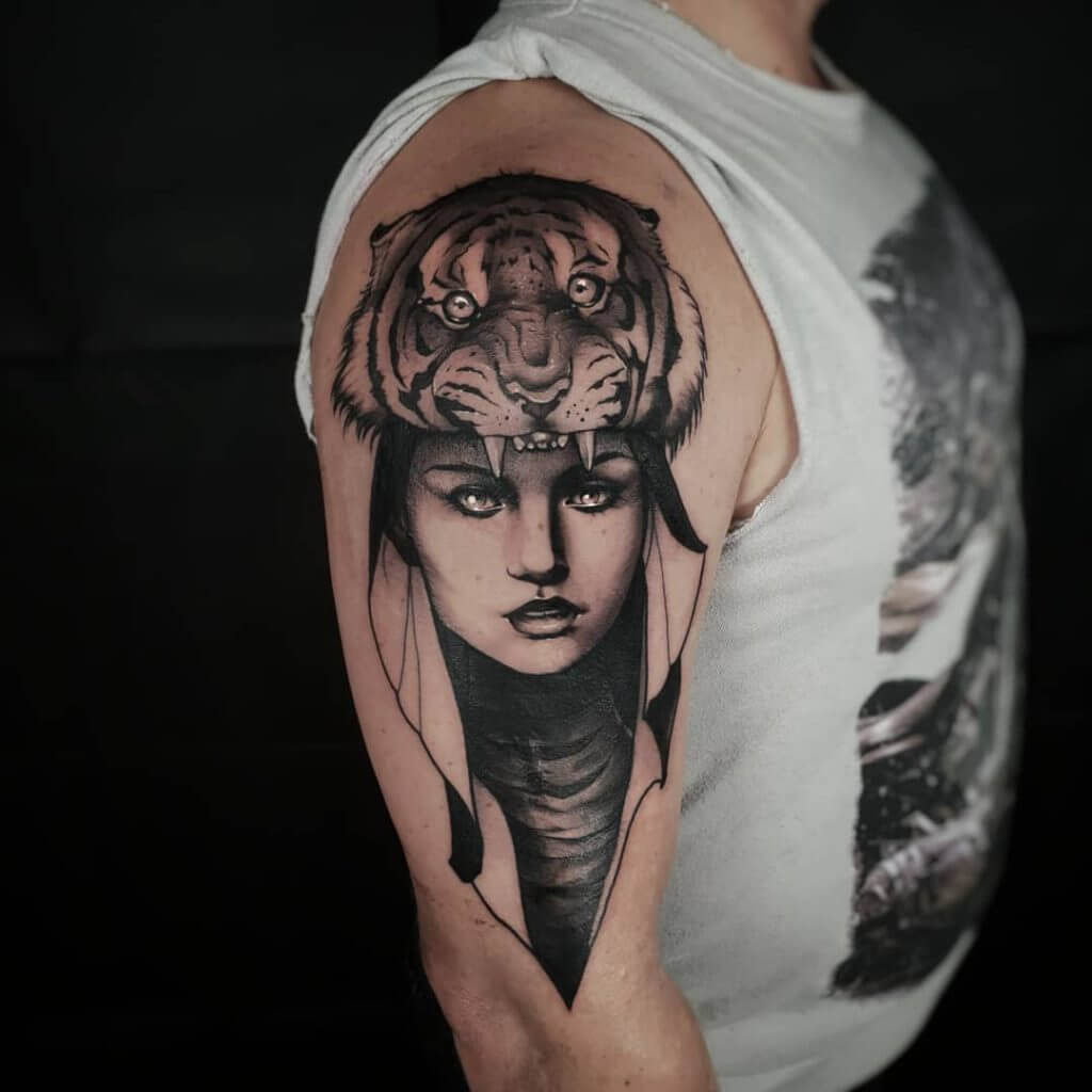 Mens neo traditional tattoo of a female face with tiger on her head, on the right shoulder