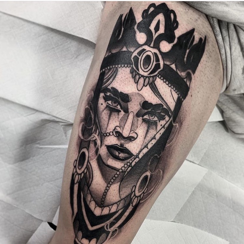 Mens black neotraditional tattoo of a woman with crown, on the right thigh