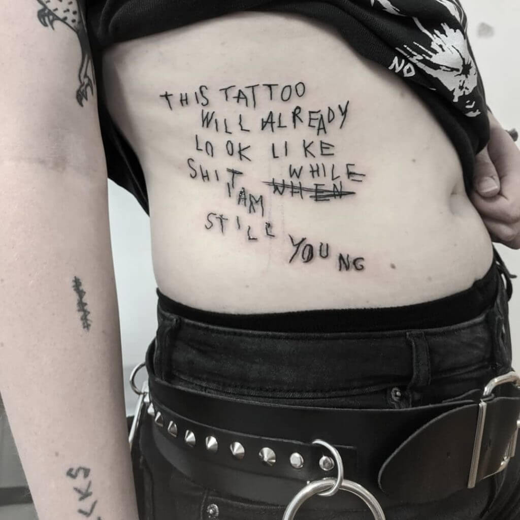 Lettering black tattoo for women on the ribs