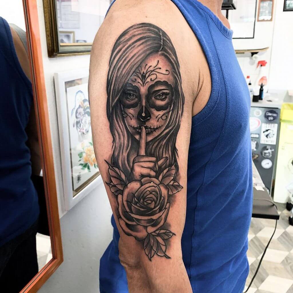 Mens black neotraditional tattoo of a woman with rose, on the right arm