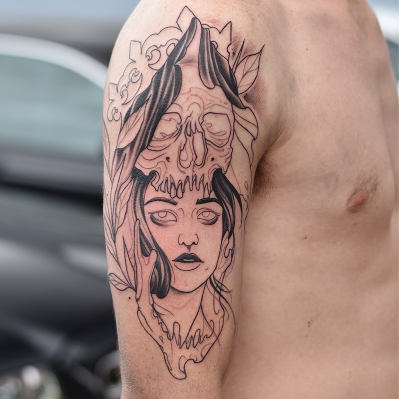 Mens neo traditional tattoo of a female face with skull on her head, on the right shoulder