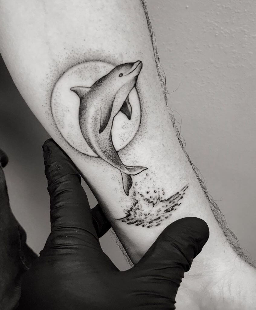 Dolphin tattoo on the arm