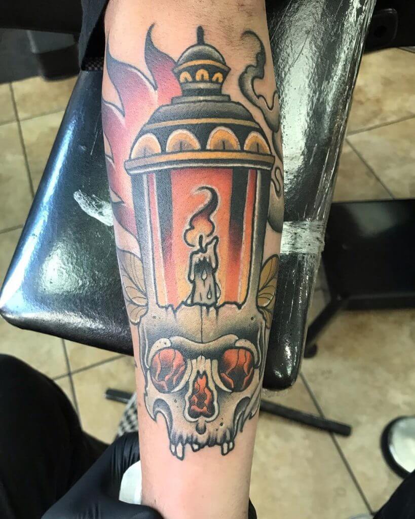 Color neo traditional tattoo of a skull with a lantern on it