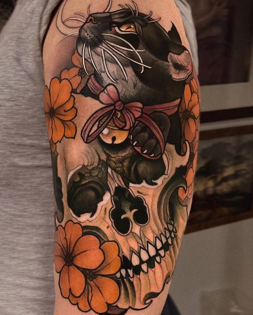 Color neotraditional tattoo with a skull, black cat and orange flowers on the left arm
