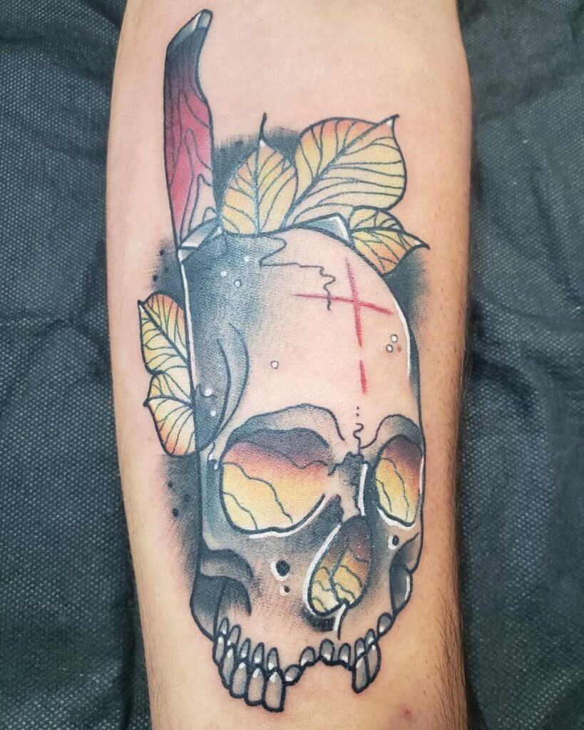 Color neotraditional tattoo with a skull, leaves and a knife