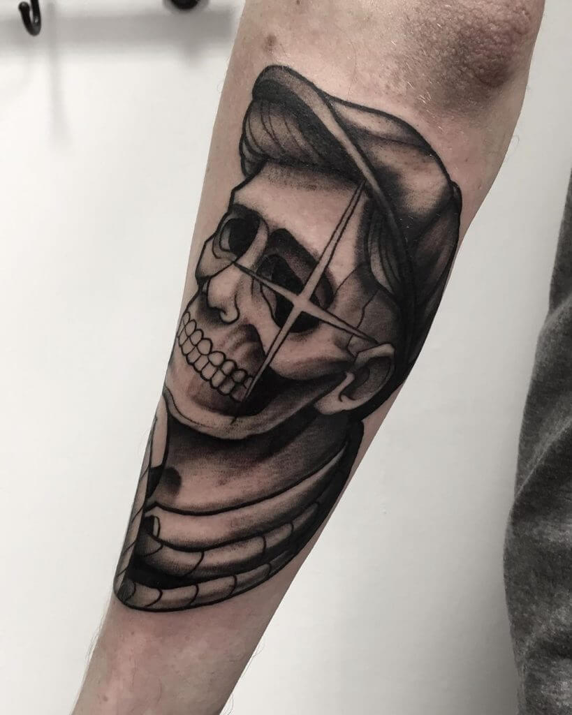 Black neotraditional tattoo with a skull on the left forearm