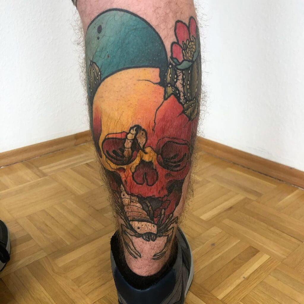 Color neotraditional tattoo of a skull with scorpion on the right calf