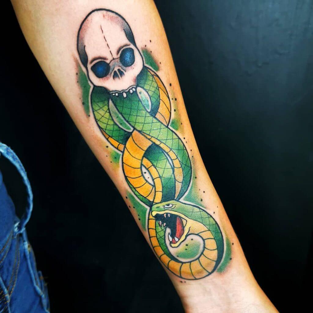 Color neotraditional tattoo of a skull with snake on the left forearm