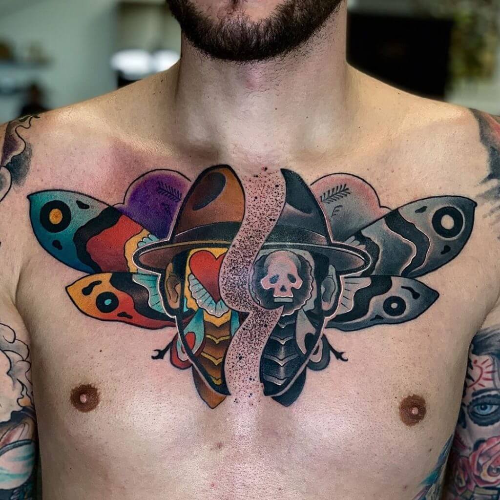 Color and black neotraditional tattoo with a skull and a butterfly wings on the chest