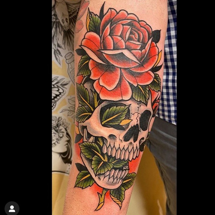 Color neotraditional tattoo with a skull and red rose on the right forearm