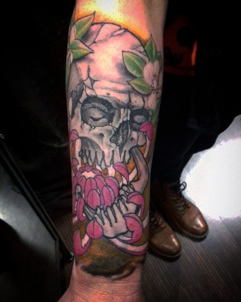 Color neo traditional tattoo with a skull on the right forearm