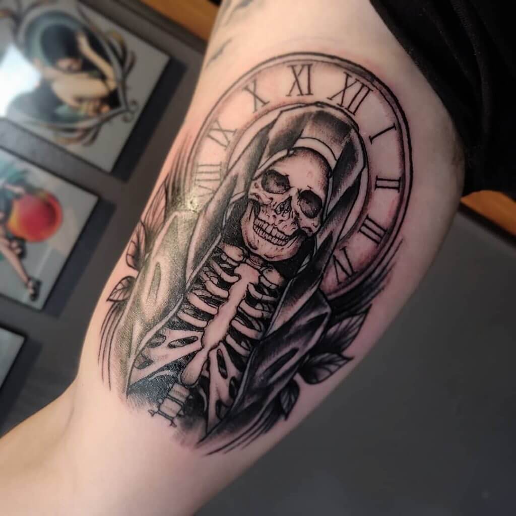 Black and gray neotraditional tattoo with a skeleton on the right arm