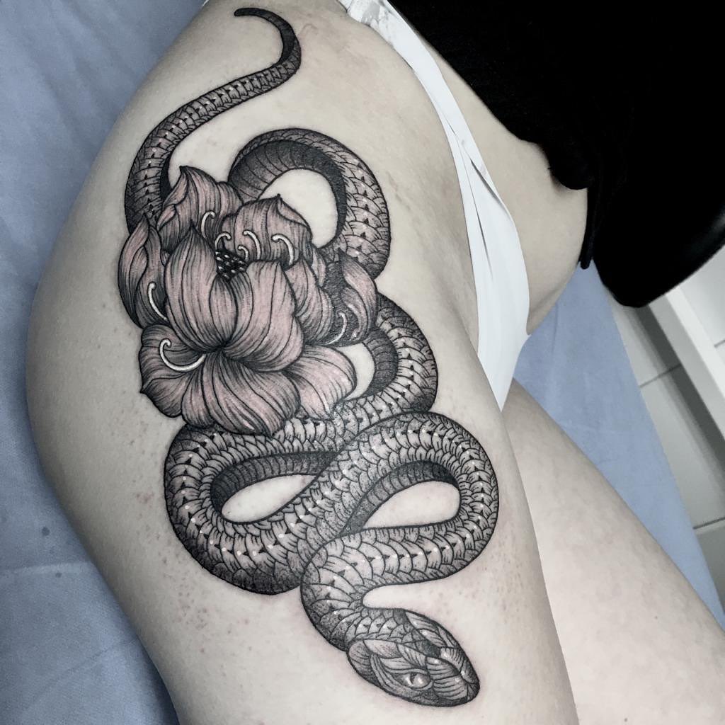 Dotwork tattoo for women of a snake with hibiscus flowers on the right thigh
