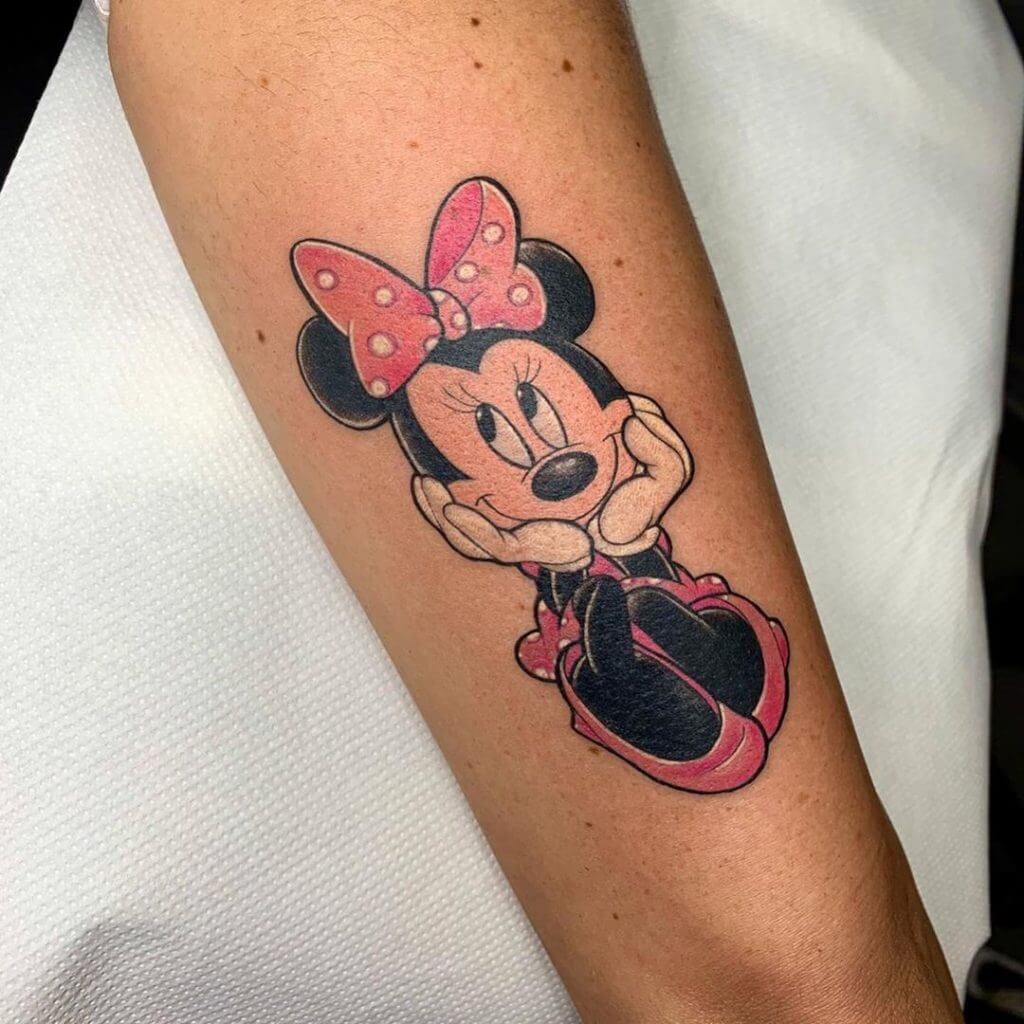 Woman cartoon tattoo of Minnie mouse on the left forearm