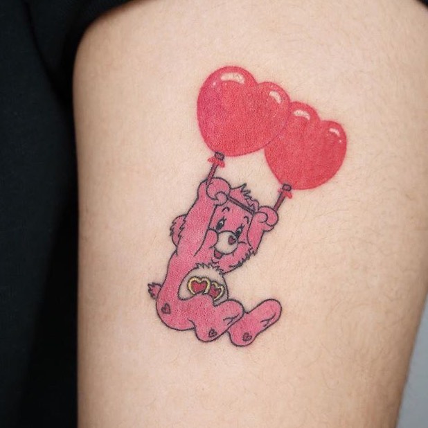 Women color cartoon tattoo of Love-A-Lot Bear care bear on the left thigh