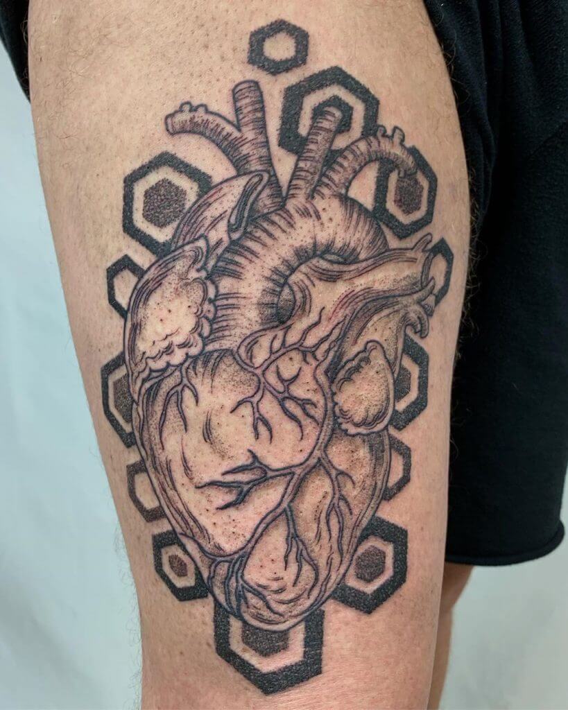 Men black and gray dotwork tattoo of a heart on the right thigh