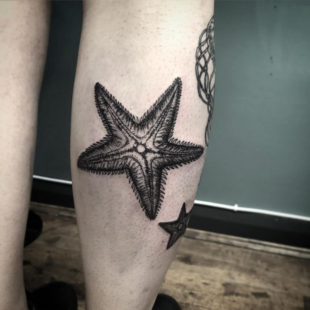 Men black dotwork tattoo of a starfish on the right calf