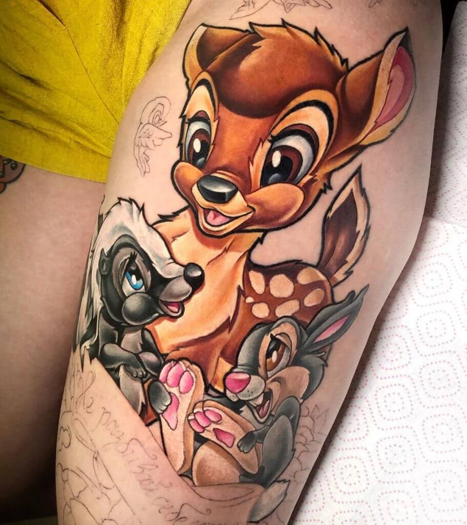 Women color cartoon tattoo of Bambie, Flower and Thumper on the left thigh
