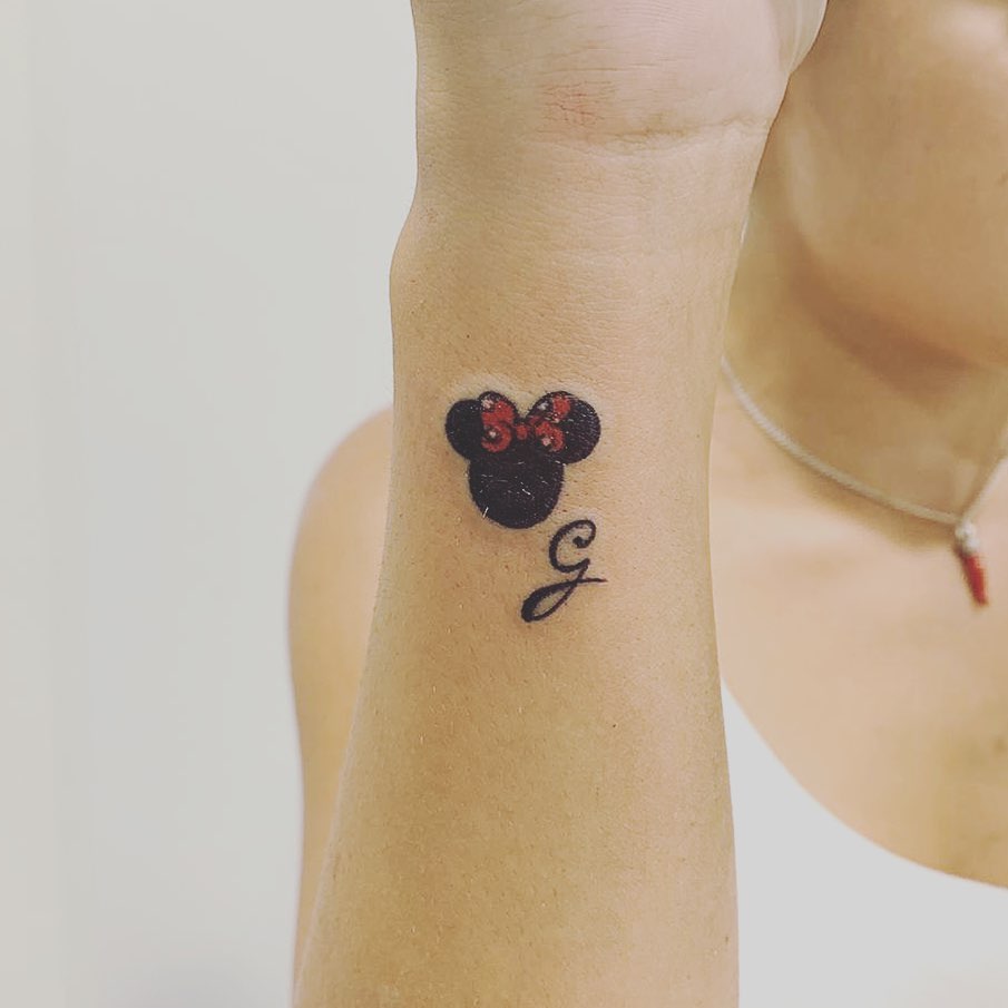 Women cartoon tattoo of Minnie mouse on the right forearm