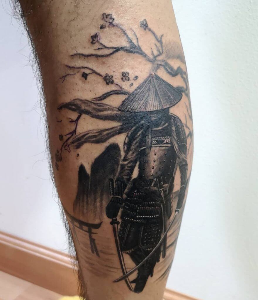 Black samurai tattoo on the right calf