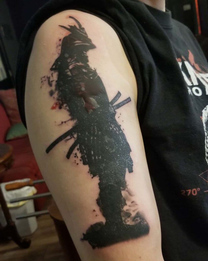 Black samurai tattoo on the right arm