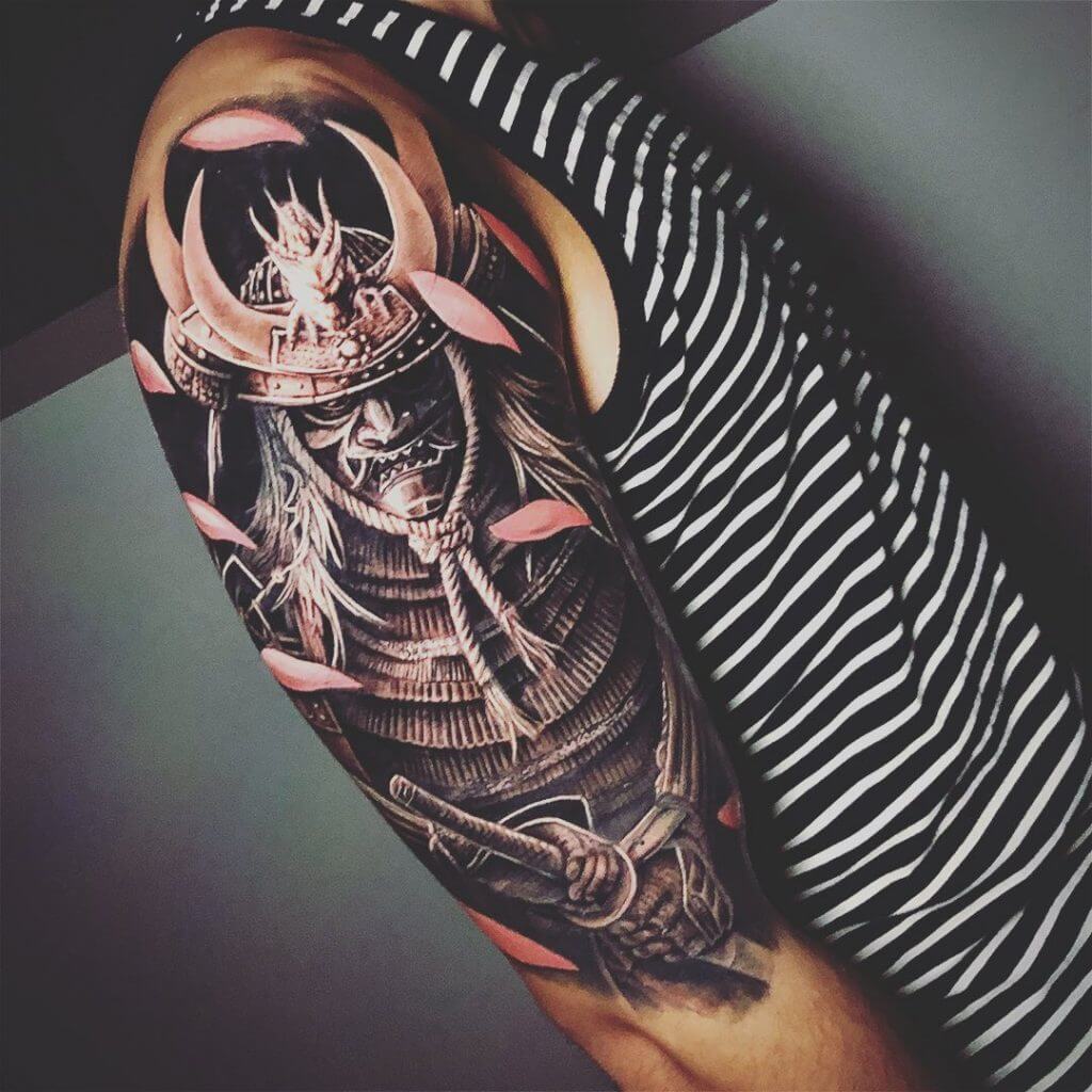 Black and gray samurai tattoo on the right arm