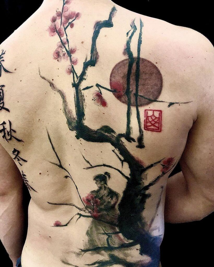 Samurai tattoo on the back with branch sakura tree